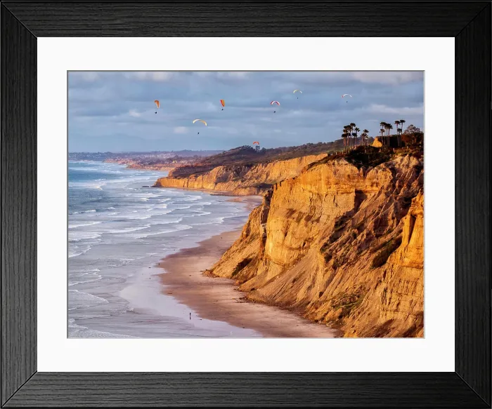 Framed Print : USA, California, La Jolla. Paragliders float over Black's Beach in late afternoon Framed Print : USA, California, La Jolla. Paragliders float over Black's Beach in late afternoon