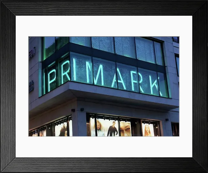 Framed Print : Primark, illuminated logo at the Duesseldorf shop