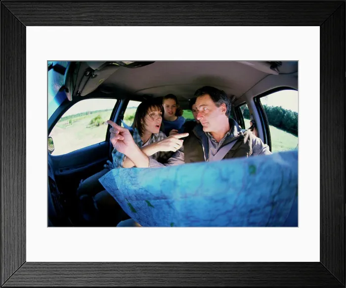 Framed Print : Couple arguing in a car over a map Framed Print : Couple arguing in a car over a map