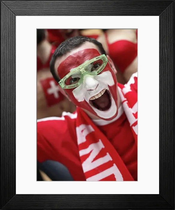 Framed Print : Football fan with their face painted in the Swiss national colours Framed Print : Football fan with their face painted in the Swiss national colours