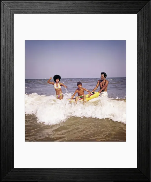 Framed Print : 1970s AFRICAN-AMERICAN FAMILY JUMPING IN OCEAN SEASHORE SURF MOTHER AND FATHER WITH SON ON INFLATABLE RAFT Framed Print : 1970s AFRICAN-AMERICAN FAMILY JUMPING IN OCEAN SEASHORE SURF MOTHER AND FATHER WITH SON ON INFLATABLE RAFT
