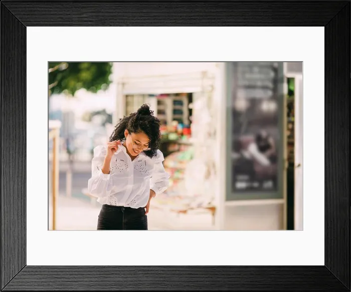 Framed Print : Happy young woman walking on urban sidewalk