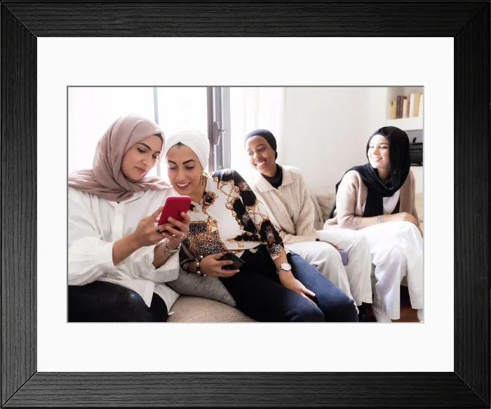 Framed Print : Four young muslim women, looking at cellphone Framed Print : Four young muslim women, looking at cellphone