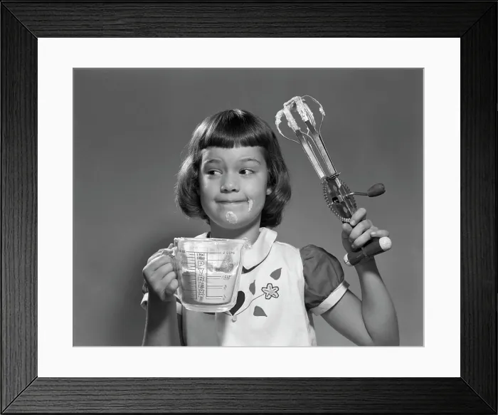 Framed Print : 1950S Smiling Girl Holding Measuring Cup Egg Beaters Cooking Mixing Food On Face Framed Print : 1950S Smiling Girl Holding Measuring Cup Egg Beaters Cooking Mixing Food On Face