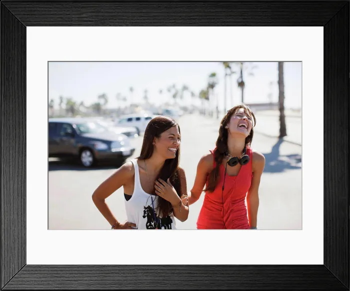 Framed Print : Los Angeles, USA, Laughing women walking outdoors