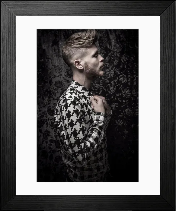 Framed Print : Studio portrait of a bearded young man in a black and white shirt