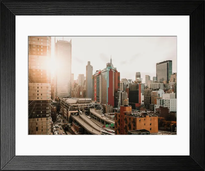 Framed Print : New York city view with modern skyscrapers in district illuminated with bright sunlight Framed Print : New York city view with modern skyscrapers in district illuminated with bright sunlight