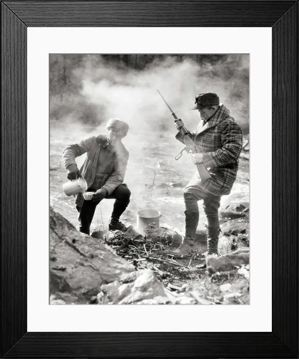 Framed Print : 1920s TWO HUNTERS STANDING CAMPED BY STREAM ONE MAKING COFFEE OVER CAMPFIRE ONE CHECKING LEVER ACTION RIFLE NEW Framed Print : 1920s TWO HUNTERS STANDING CAMPED BY STREAM ONE MAKING COFFEE OVER CAMPFIRE ONE CHECKING LEVER ACTION RIFLE NEW