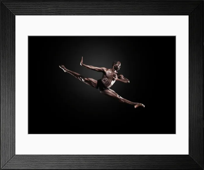 Framed Print : Dancer Lloyd Boyd mid air against a dark studio background. Bodies in Action