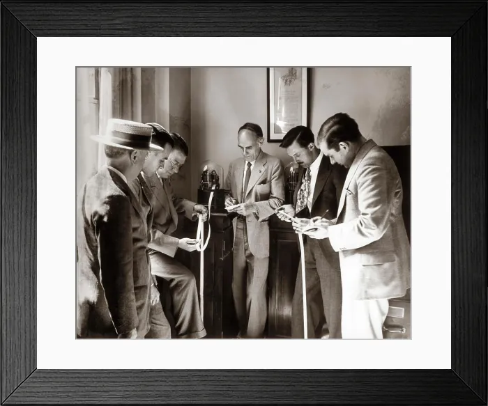 Framed Print : 1930S Brokers Businessmen Reading Ticker Tape As It Comes Out Of Glass Domed Machine