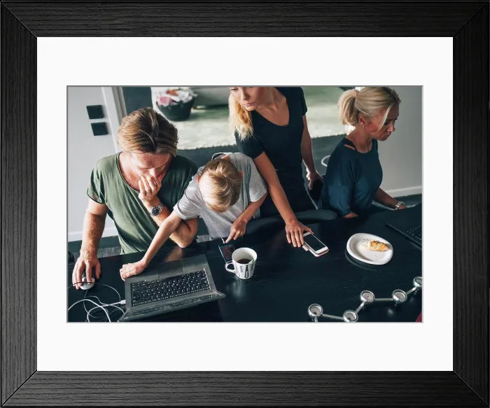 Framed Print : High angle view of family using technologies at dining table in room