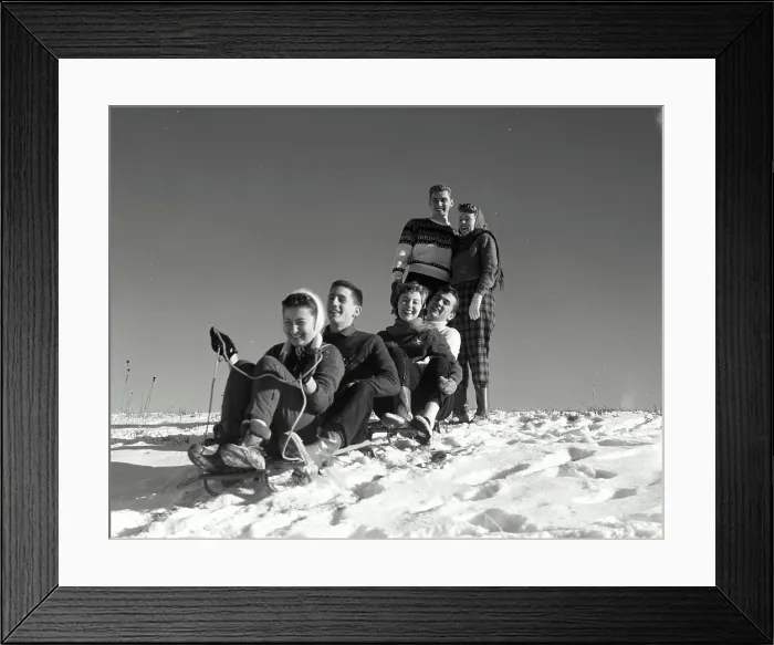 Framed Print : Vintage Photograph. Two couples sledding down snow covered hill as another watches at top Framed Print : Vintage Photograph. Two couples sledding down snow covered hill as another watches at top