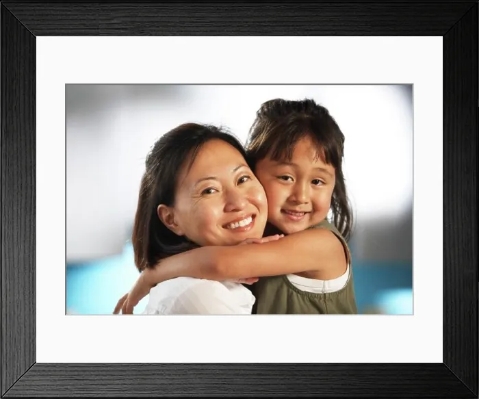 Framed Print : Portrait of a mid adult woman hugging her daughter Framed Print : Portrait of a mid adult woman hugging her daughter