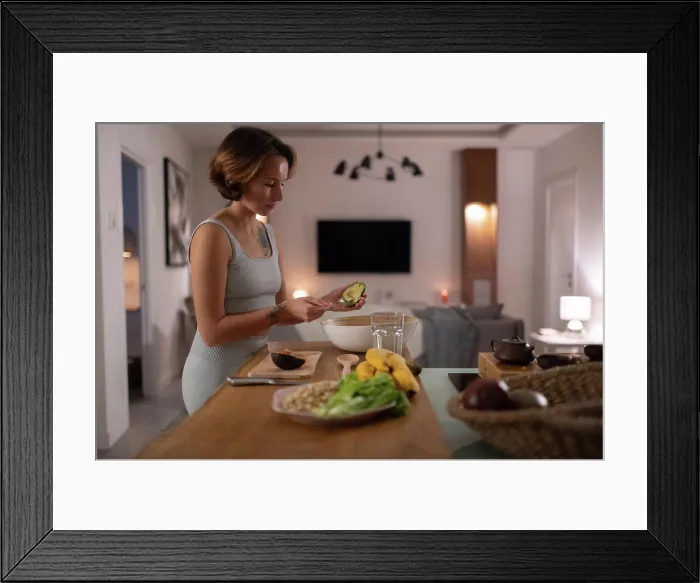 Framed Print : Young woman preparing avocado salad Framed Print : Young woman preparing avocado salad