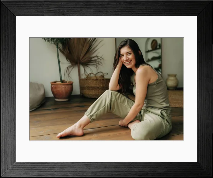 Framed Print : Portrait of a happy cheerful beautiful young brunette woman sitting on the floor