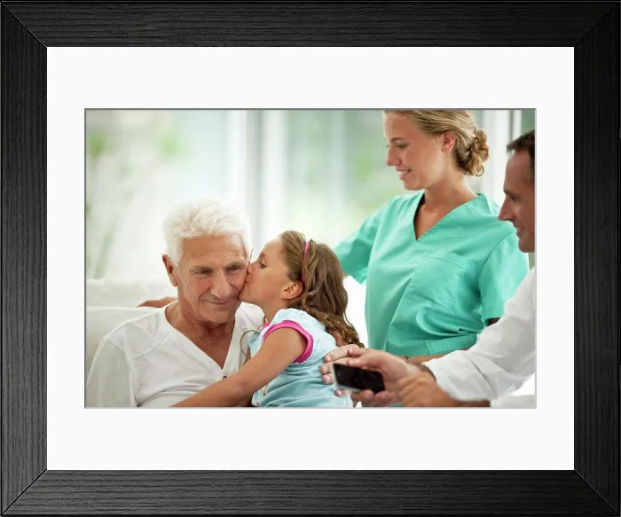 Framed Print : Elderly man receiving a hospital visit from his granddaughter Framed Print : Elderly man receiving a hospital visit from his granddaughter