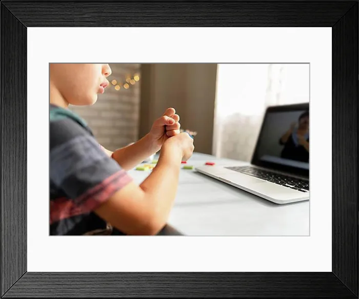 Framed Print : Boy talking with his teacher online school Framed Print : Boy talking with his teacher online school