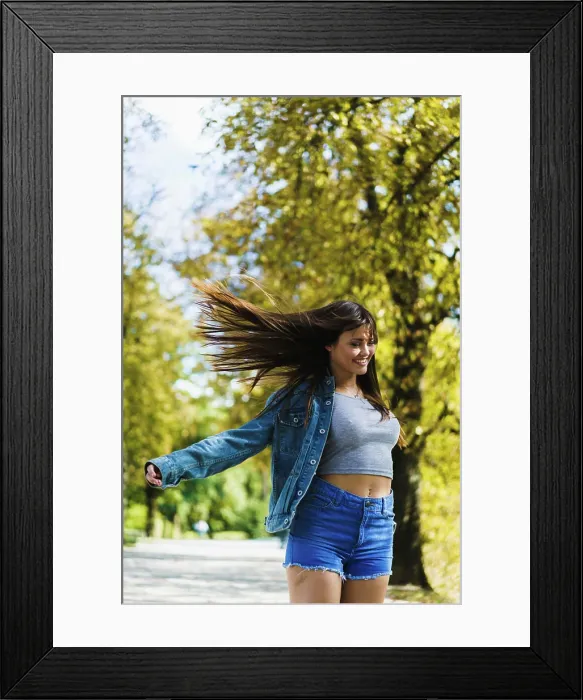 Framed Print : Smiling woman with flying hair walking in sunny autumn park