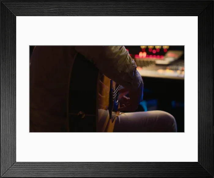 Framed Print : Young composer songwriter recording his guitar tunes in professional studio Framed Print : Young composer songwriter recording his guitar tunes in professional studio