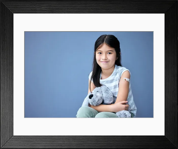 Framed Print : Plaster, portrait and girl child with teddy bear for comfort in studio isolated on blue background