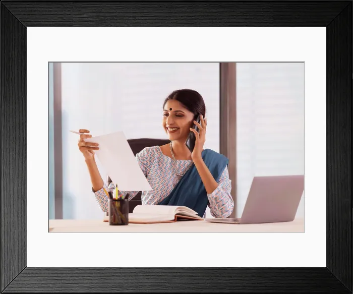 Framed Print : Woman talking on mobile phone in office Framed Print : Woman talking on mobile phone in office