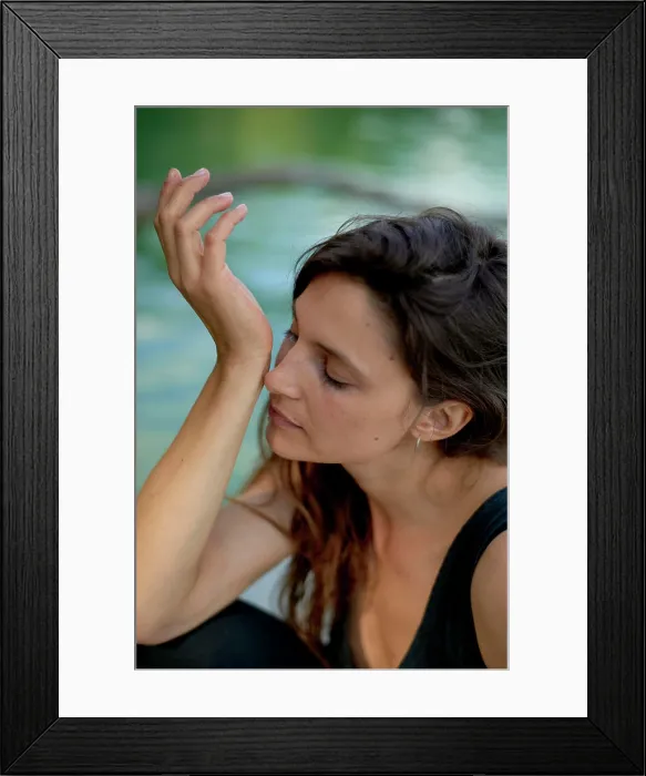 Framed Print : Woman in a black tank top enjoying a peaceful moment by the water with her eyes closed