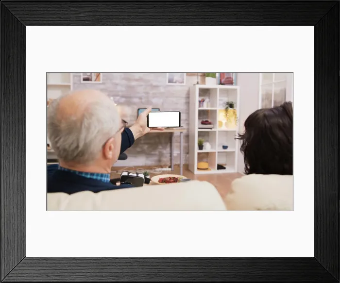 Framed Print : Back view of elderly age couple looking at phone with green screen