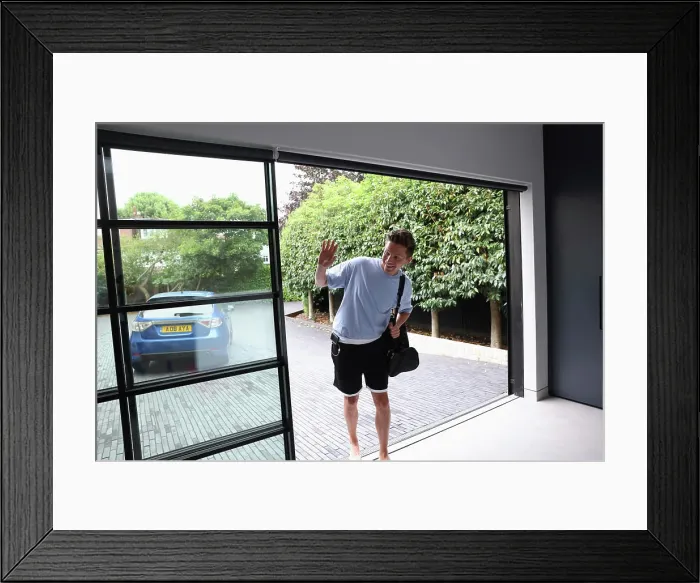 Framed Print : Smiling man walking insidegym with shoulder bag and waving Framed Print : Smiling man walking insidegym with shoulder bag and waving