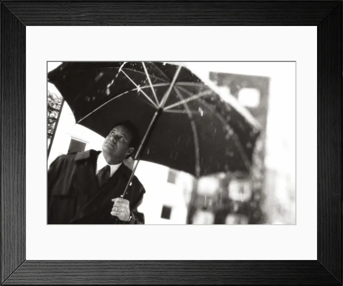 Framed Print : Businessman holding an umbrella Framed Print : Businessman holding an umbrella