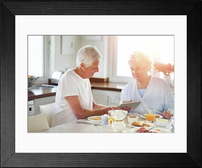 Framed Print : Senior couple, tablet and eating food in kitchen on social media Framed Print : Senior couple, tablet and eating food in kitchen on social media