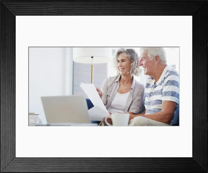 Framed Print : Laptop, old couple and document on couch for budget Framed Print : Laptop, old couple and document on couch for budget