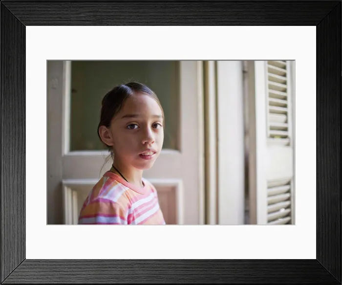 Framed Print : Portrait of a girl standing in a room Framed Print : Portrait of a girl standing in a room