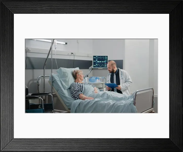 Framed Print : Doctor talking to elder patient about disease and treatment Framed Print : Doctor talking to elder patient about disease and treatment