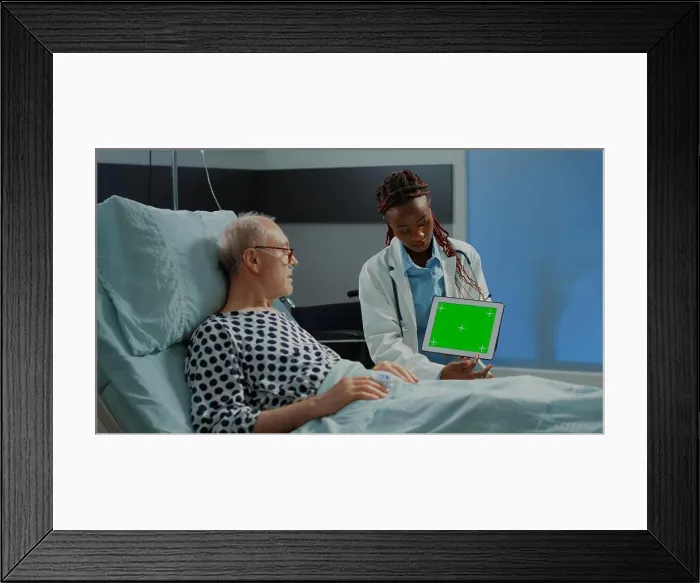 Framed Print : Specialist woman showing green screen on tablet to patient Framed Print : Specialist woman showing green screen on tablet to patient