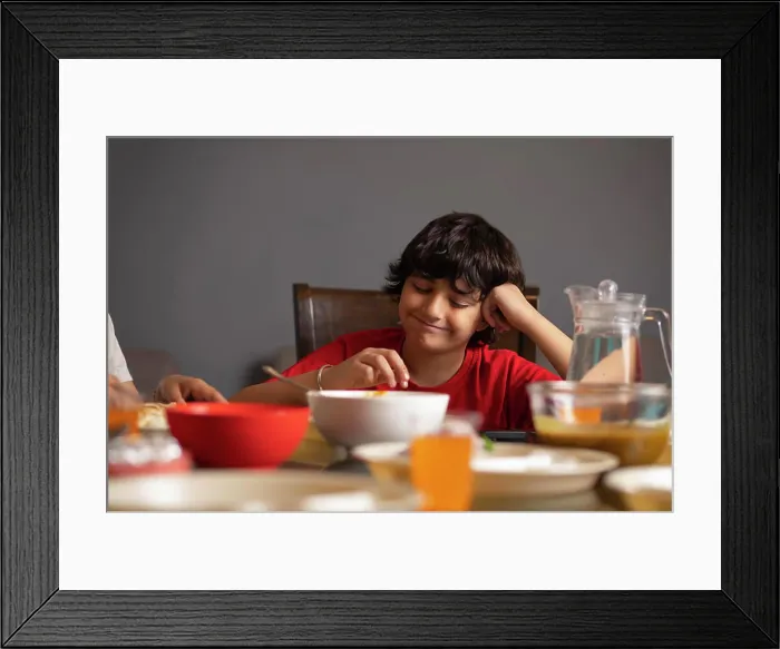 Framed Print : Portrait of boy having lunch at home Framed Print : Portrait of boy having lunch at home