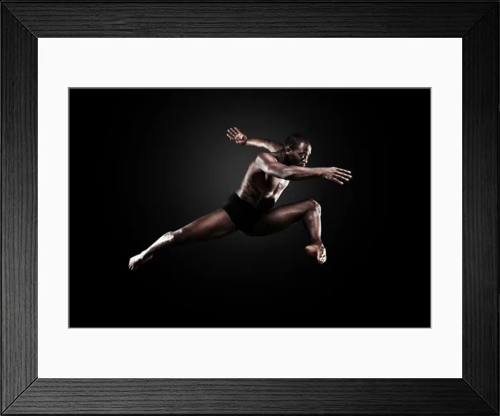 Framed Print : Dancer Lloyd Boyd mid air against a dark background. Bodies in Action