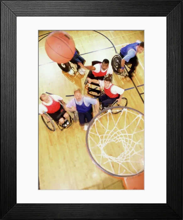 Framed Print : High angle view of a group of mid adult men in wheelchairs playing basketball Framed Print : High angle view of a group of mid adult men in wheelchairs playing basketball