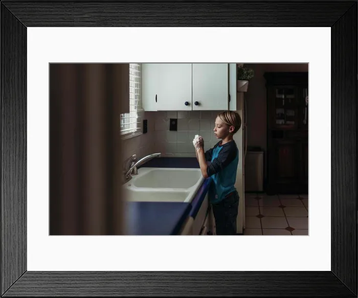 Framed Print : Side view of school aged boy wasking hands at sink in kitchen Framed Print : Side view of school aged boy wasking hands at sink in kitchen