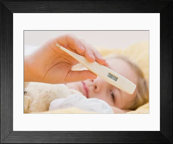Framed Print : Sick girl with clinical thermometer in bed Framed Print : Sick girl with clinical thermometer in bed