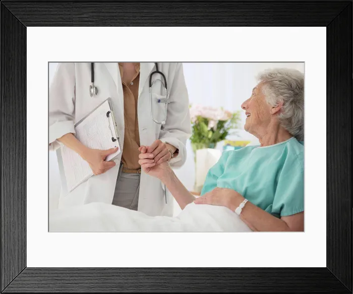 Framed Print : Doctor and aging patient holding hands in hospital Framed Print : Doctor and aging patient holding hands in hospital