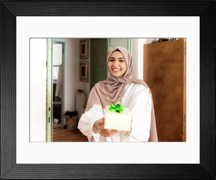 Framed Print : Young muslim woman giving a gift Framed Print : Young muslim woman giving a gift