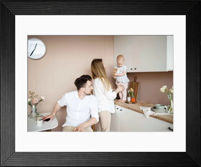 Framed Print : Parents communicate with little child in kitchen during breakfast