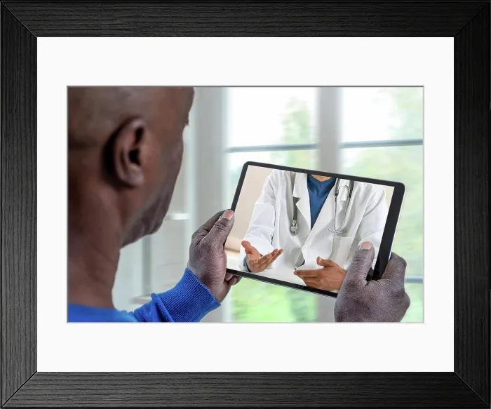 Framed Print : Patient listening to his doctor through the tablet Telemedicine-Patient in front of his doctor 016278_037
