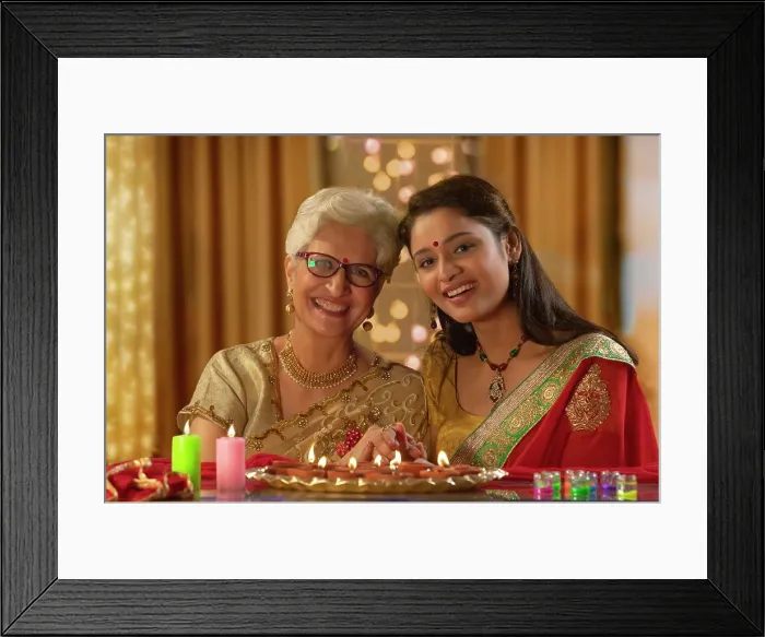 Framed Print : Daughter in law decorating the house with mother in law on the occasion of diwali Framed Print : Daughter in law decorating the house with mother in law on the occasion of diwali