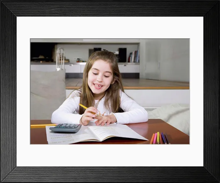 Framed Print : A little girl doing her homework Framed Print : A little girl doing her homework