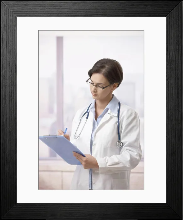 Framed Print : Female doctor doing paperwork in hospital Attractive female doctor standing on hospital corridor doing paperwork Framed Print : Female doctor doing paperwork in hospital Attractive female doctor standing on hospital corridor doing paperwork