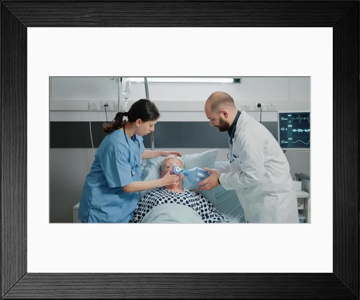 Framed Print : Doctor and nurse using oxygen tube and oximeter on ill patient Framed Print : Doctor and nurse using oxygen tube and oximeter on ill patient