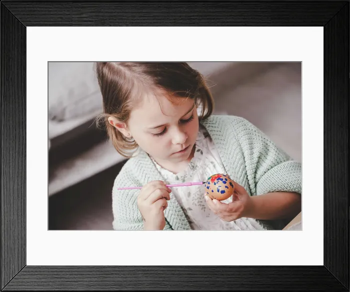 Framed Print : Girl coloring chicken egg at table Framed Print : Girl coloring chicken egg at table