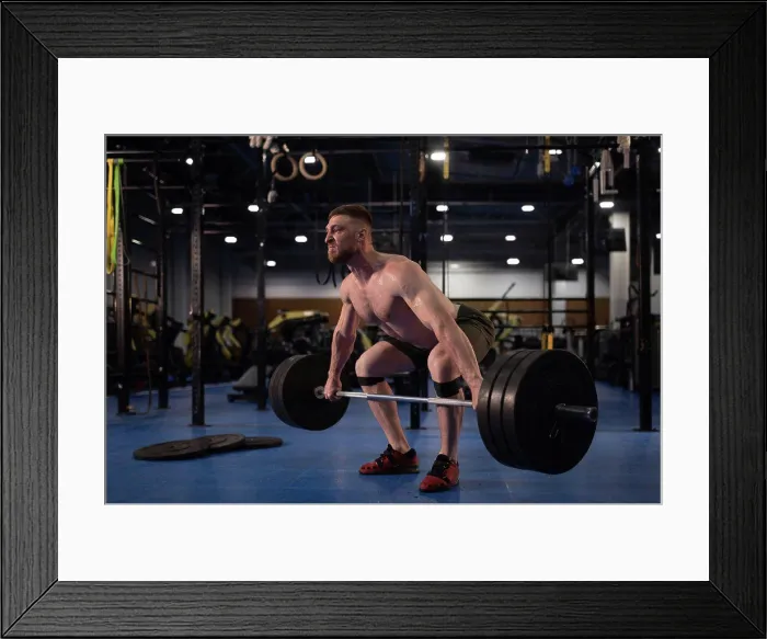 Framed Print : Masculine weightlifter squatting with barbell Framed Print : Masculine weightlifter squatting with barbell