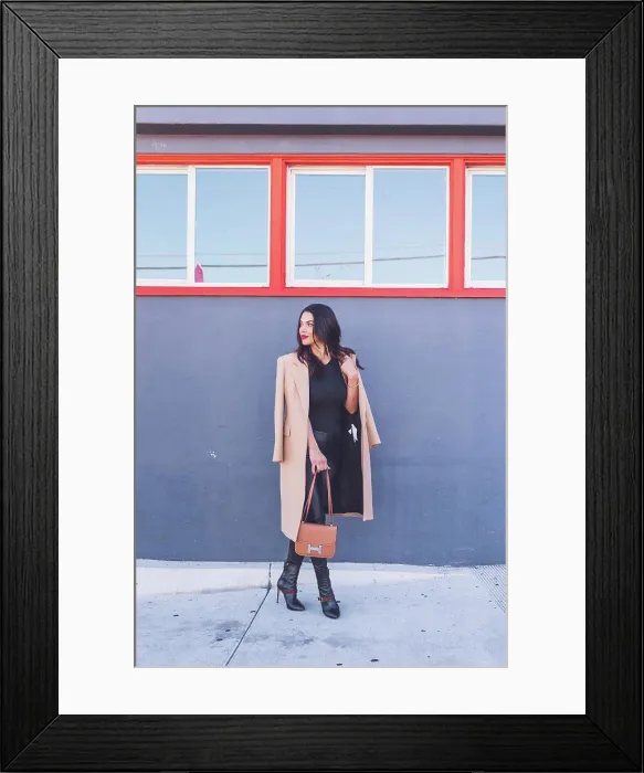 Framed Print : Friendly business woman standing in front of gray wall, orange windows Framed Print : Friendly business woman standing in front of gray wall, orange windows